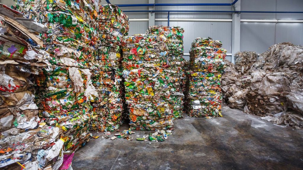 plastic recycling bales stacked in warehouse