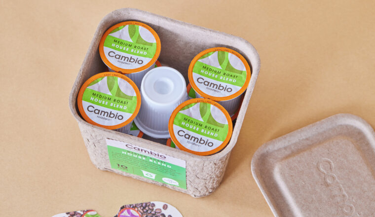 Eco-friendly Cambio coffee pods in sustainable and creative packaging design on a beige background.
