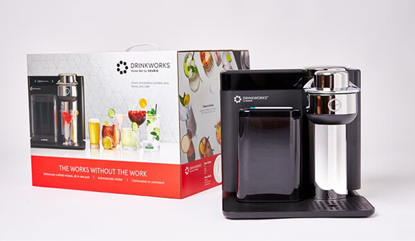 Home bar appliance by Drinkworks displayed next to its sleek packaging design with cocktail images.